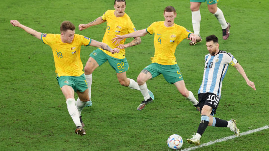 Lionel Messi of Argentina takes on Harry Souttar, Jackson Irvine and Kye Rowles of Australia.