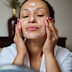 Stock image of a woman applying skincare