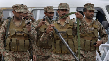 Pakistani troops arrive at a polling station in Rawalpindi to provide security for election staff.