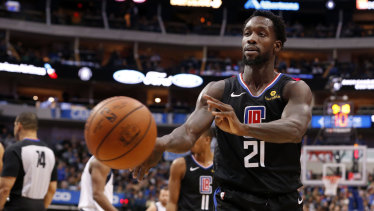 Clippers guard Patrick Beverley throws a ball at a fan.