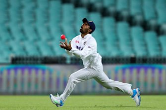 Wriddhiman Saha catches out Nic Maddinson at the SCG on Friday.