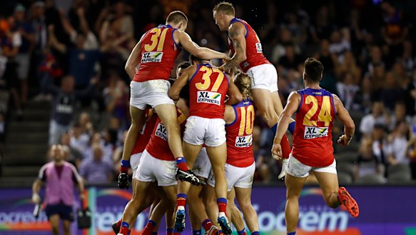 Brisbane Lions players celebrate an after the siren goal to win the game by Zac Bailey. 