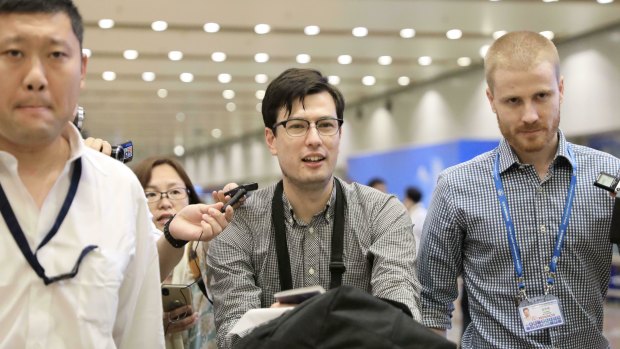 Australian student Alek Sigley smiles as he arrives at the airport in Beijing on Thursday. 