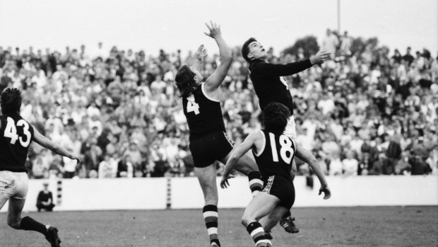 Tony Lockett and Steven Silvagni compete in the air.