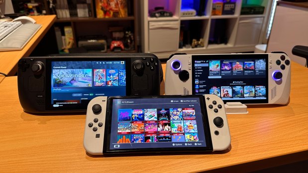 Valve’s Steam Deck (left) lets you take  games from its online store with you, while the Nintendo Switch (front) is by far the most popular currently-sold video games machine.