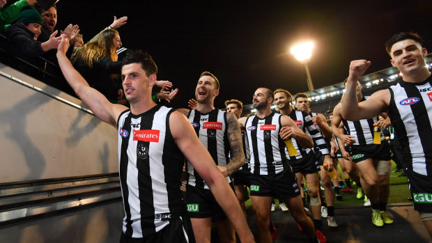 Pie and mighty: Jubilant Collingwood players walk off the MCG ground after their win over GWS.