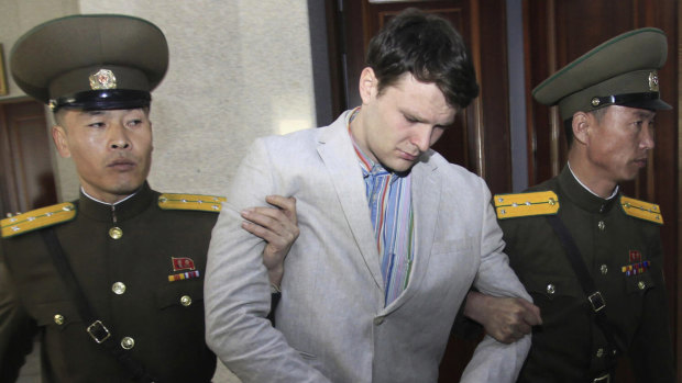 American student Otto Warmbier, who fell into a coma and later died after being arrested in North Korea, is pictured being escorted into the Supreme Court in Pyongyang, North Korea. 