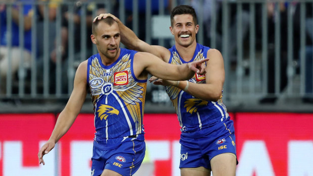 On point: The Eagles celebrate another major, off the boot of Dom Sheed (left).