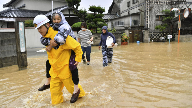 Residents are evacuated to a safer place from floodwaters in Kurashiki, Okayama prefecture, Japan.