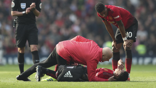 Jesse Lingard receives treatment at Old Trafford.