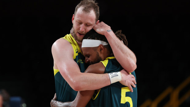 At last: Joe Ingles holds Patty Mills tight after the Boomers’ emotion-laden win over Slovenia to claim bronze.