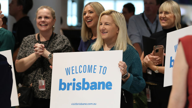 Airport staff greet the first passengers back from Sydney since the Queensland borders re-opened on Tuesday.