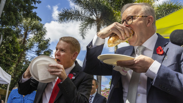 Kiwi politician Chris Hipkins (left) and Australian Prime Minister Anthony Albanese tuck in at a citizenship ceremony in Brisbane.