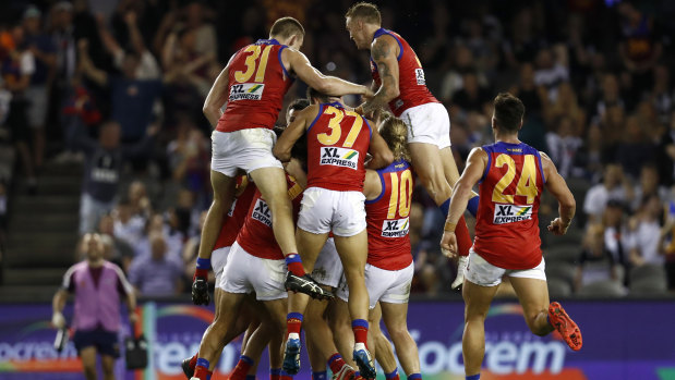 Brisbane Lions players celebrate an after the siren goal to win the game by Zac Bailey. 