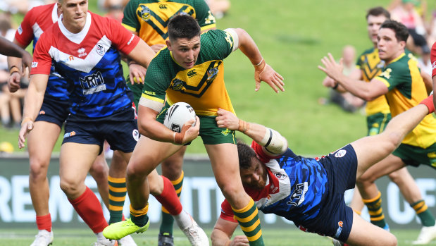 Junior Kangaroos man of the match Victor Radley busts a tackle on Friday.