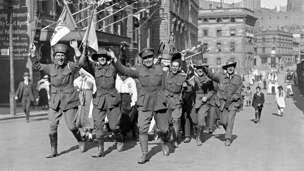 Returned soldiers and supporters march along Hunter Street to celebrate Armistice Day, 1918.