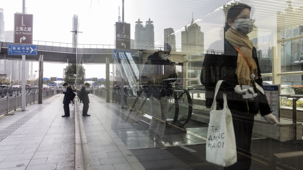 Passengers leave a subway station in Shanghai on Thursday. 