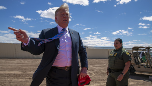 US President Donald Trump visits a section of the border wall in April 2019. 