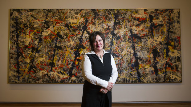 Senior Curator of International Art Lucina Ward in front of the Blue Poles. 