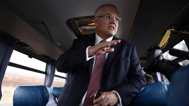 Prime Minister Scott Morrison gets on the media bus after visiting Premium Fresh carrot farm near Forth, Tasmania. 