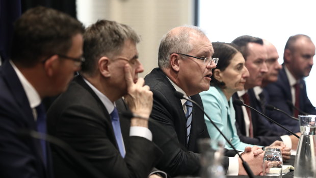 Prime Minister Scott Morrison addresses the media with premiers, chief ministers and Chief Medical Officer Brendan Murphy following a Council of Australian Governments meeting in Sydney on Friday.