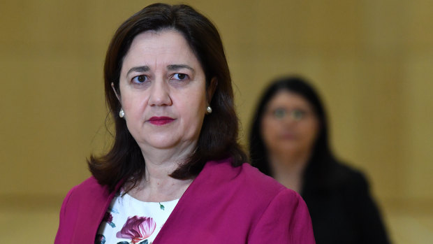 Premier Annastacia Palaszczuk announcing students' return to school with Education Minister Grace Grace (background).