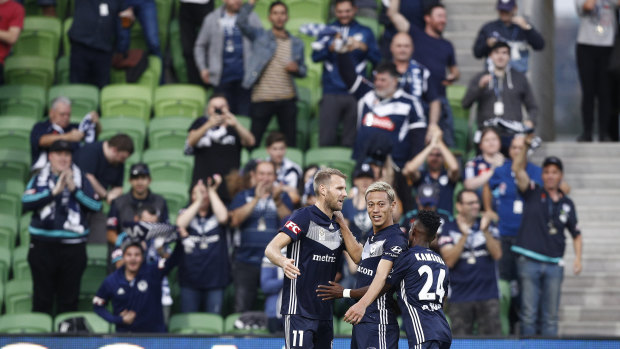 Leading the line: Victory striker Ola Toivonen (left) opened the scoring, and celebrated his effort with Keisuke Honda, Elvis Kamsoba in front of home fans.