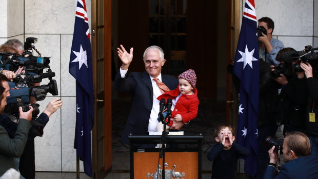Malcolm Turnbull, with two of his grandchildren, waves after addressing the media as prime minister for the final time.