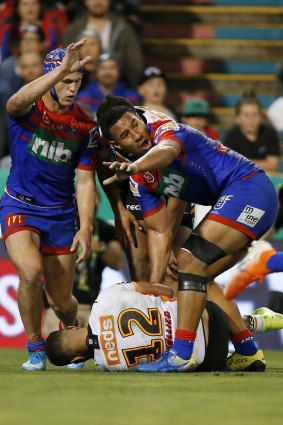 Kalyn Ponga, left, motions to the sideline after his hit on Michael Chee Kam.