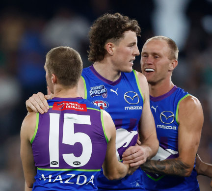 Dylan Stephens, Nick Larkey and Jaidyn Stephenson of the Kangaroos celebrate a goal.