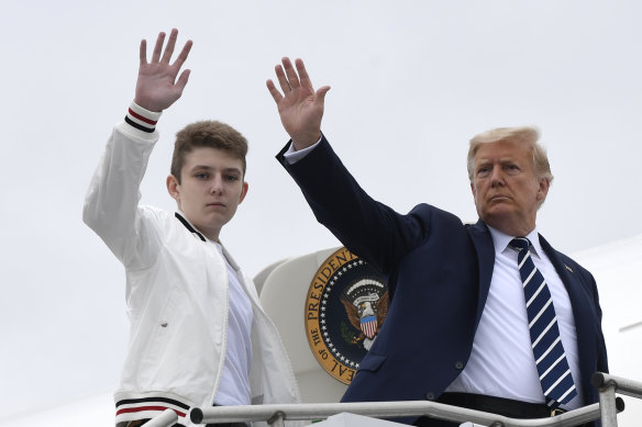 President Donald Trump, right, and his son Barron Trump board Air Force One in 2020.
