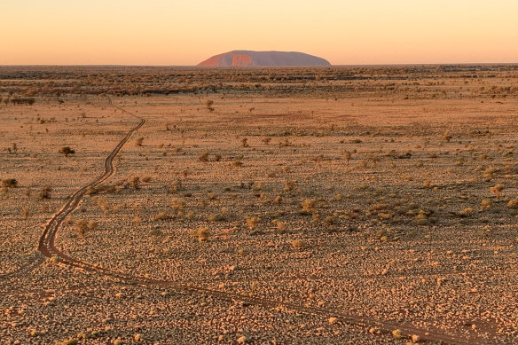 Uluru fades in the distance.