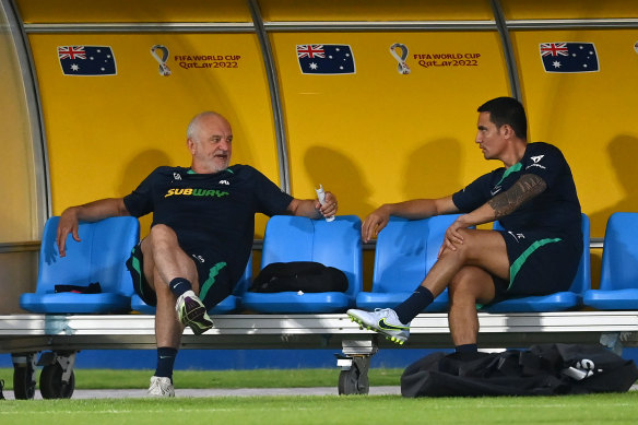 Graham Arnold and Tim Cahill chew the fat at the Aspire Academy in Doha.