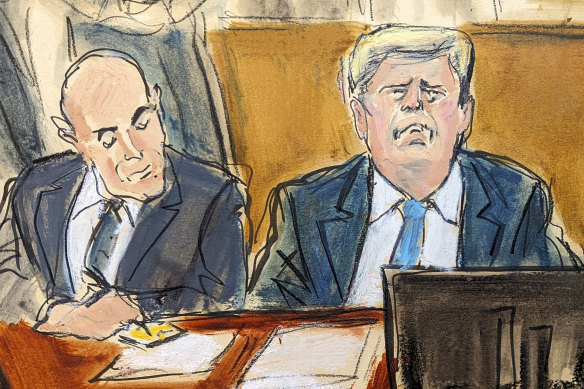 Former President Donald Trump (right) and his attorney Emil Bove watch a video screen of Stormy Daniels testifying in Manhattan criminal court.