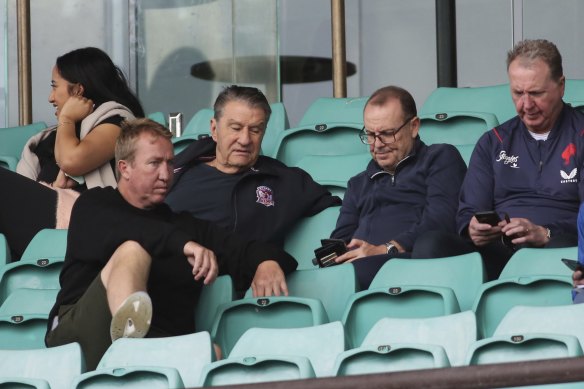 Coach Trent Robinson chats with chairman Nick Politis and Roosters powerbrokers.
