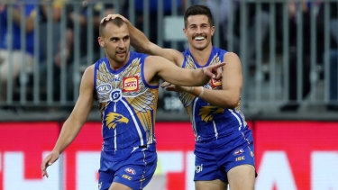 On point: The Eagles celebrate another major, off the boot of Dom Sheed (left).