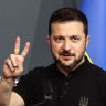 Ukraine’s President Volodymyr Zelensky flashes a V sign after his closing press conference during the Summit on Peace in Ukraine