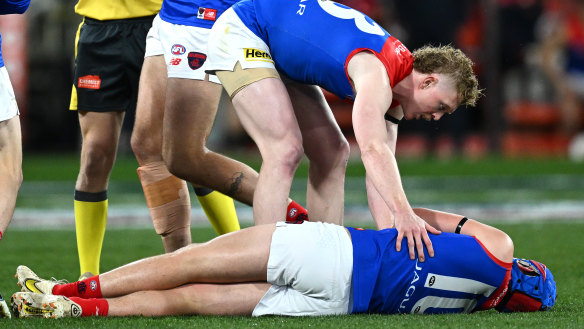 Concerned teammate Clayton Oliver checks on Melbourne’s Angus Brayshaw after he was knocked out after clashing with Collingwood’s Brayden Maynard during the 2023 finals series.