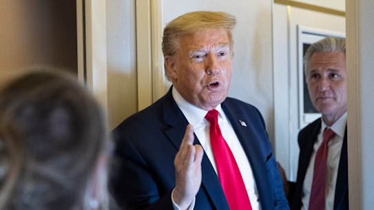 President Donald Trump speaks with reporters while in air en route to Andrews Air Force Base.