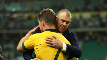 Wallabies coach Michael Cheika  and captain Michael Hooper embrace after Australia's loss to England.