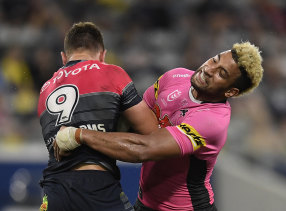 Penrith forward Viliame Kikau puts a hit on North Queensland's Reuben Cotter.