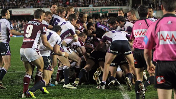 Manly and Melbourne players go at it on the halfway line at Brookvale.