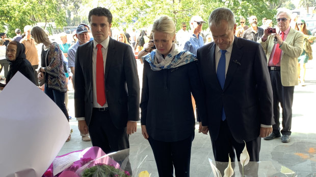 Tim Watts, Chloe Shorten and Bill Shorten lay flowers at a tribute to the victims of the Christchurch terror attack at the Australian Islamic Centre in Newport. 
