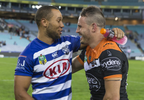 Remember me: Josh Reynolds greets former teammate Moses Mbye after the  Tigers beat the Bulldogs on Sunday.