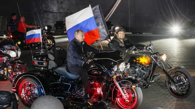 Russian President Vladimir Putin on a ride through Novorossiysk, Russia, with Night Wolves founder Alexander Zaldostanov in 2011.