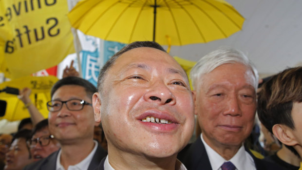 Occupy Central leaders, from left, Chan Kin-man, Benny Tai and Chu Yiu-ming enter a court in Hong Kong on Wednesday.