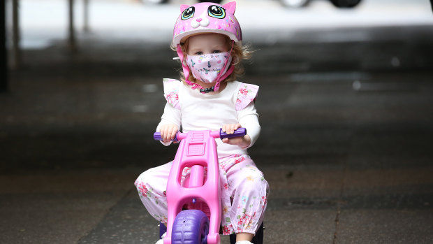 Elodie wears a mask as she rides her bike in Brisbane on Saturday, January 9, during the three-day lockdown.