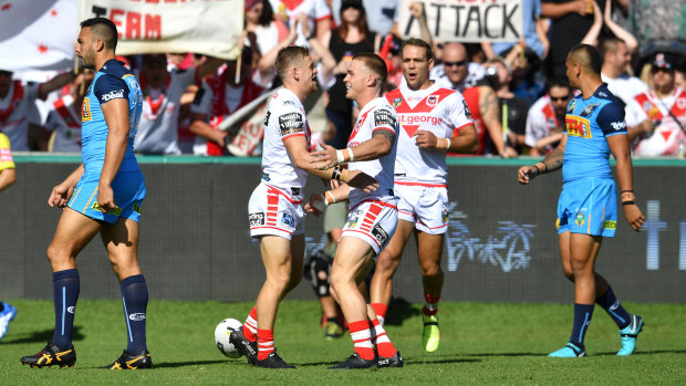 Harder they fall: Gold Coast Titans were blown away by the Dragons.