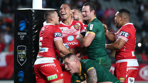 Red and white parade: Tonga celebrate Will Hopoate's try.