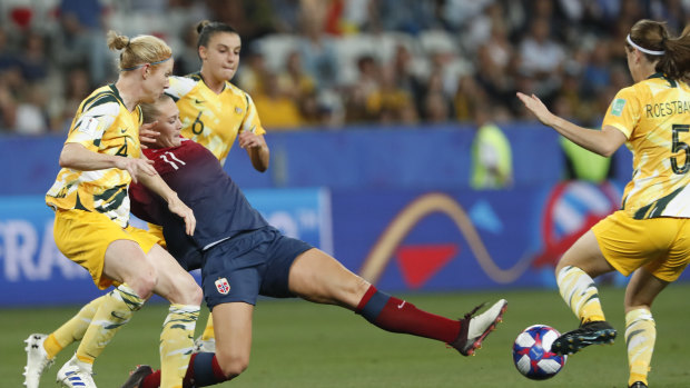 Worthy replacement: Karly Roestbakken, right, attempts to stop Norway's Lisa-Marie Utland in the Matildas' lat match in France.